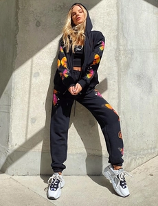 Close-up detail of vibrant colorful butterfly print on black cotton streetwear tracksuit set
