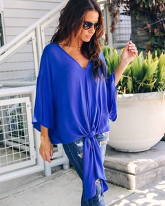 Detail of royal blue V-neck chiffon blouse featuring kimono sleeves and a front tie knot