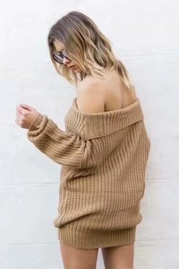 Close-up of khaki off-shoulder knit sweater showing chunky cable knit texture and ribbed cuffs