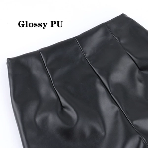 Close-up of black matte PU leather pants featuring side zipper and high waist stitching