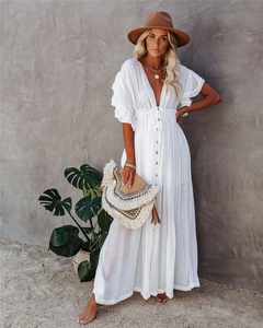 Detailed view of bohemian white maxi dress featuring V-neck and ruffled butterfly sleeves