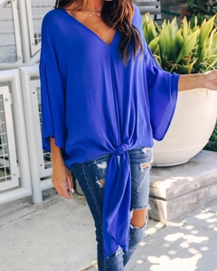 Close-up of royal blue V-neck chiffon blouse featuring a stylish front tie knot detail