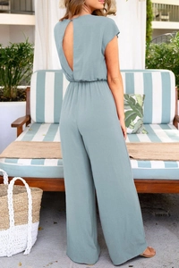 Back view of sage green v-cut back jumpsuit with elastic waist and wide leg trousers