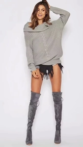 Close-up of grey cable-knit texture on oversized wide-collar long-sleeved sweater