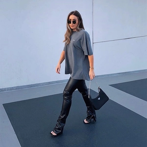 Women's matte PU leather elastic leggings with side slit zipper hem and slim fit design
