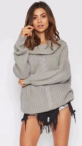 Detail of grey cable knit sweater featuring a stylish off-shoulder fold-over collar design