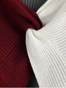 Macro detail of ribbed knit fabric texture in wine red, white and grey color blocks