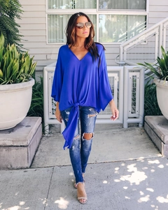 Detail of royal blue chiffon blouse featuring a chic V-neck and a front-knot waist design