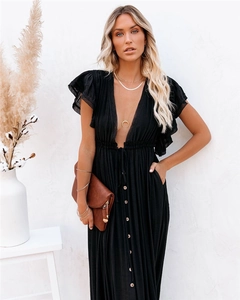 Close-up of elegant deep V-neck and decorative wooden buttons on the black maxi dress