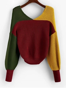 Close-up of color-block knit sweater detail showing green, yellow and red ribbed textures