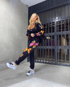 Detailed view of colorful butterfly print on black casual streetwear tracksuit set