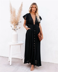 Close-up of black V-neck maxi dress with decorative buttons and ruffle sleeves
