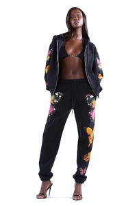 Close-up of vibrant butterfly print on black zip-up hoodie and matching joggers set