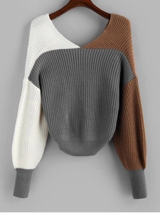 Detail of multi-color ribbed knit fabric and V-neckline of long-sleeve sweater