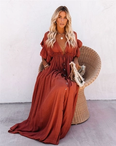 Detail of V-neck rust red maxi dress with ruffle sleeves and button-down front on a model