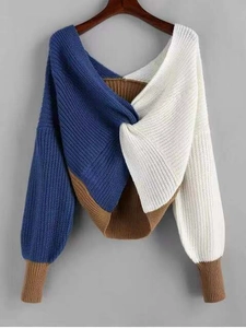 Detail of multi-color knit sweater featuring a twist front knot and V-neckline texture