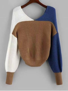 Detail of color-block knit sweater featuring V-neckline and coarse knit texture