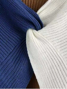 Detailed macro view of the knitted texture with a twist knot in blue and white contrast