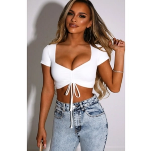 Sexy white deep V-neck crop top with drawstring detail and high waist light blue jeans