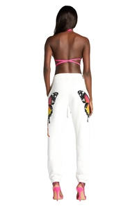 Detail of colorful butterfly prints on white jogging pants with elastic ankle cuffs