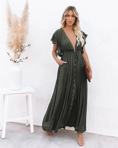 Detailed close-up of dark green V-neck dress featuring buttons and ruffled sleeve texture