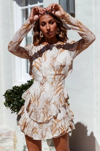 Detail of multi-layered ruffle hem and leaf print on a long sleeve cream chiffon dress