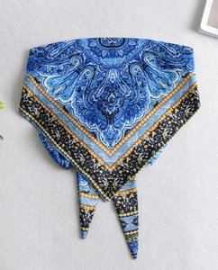 Detail of royal blue paisley print satin scarf showing intricate floral patterns and texture