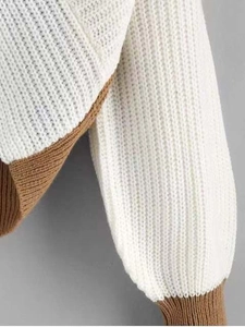 Detail of ribbed knit texture with white and brown contrast panels on the women's sweater
