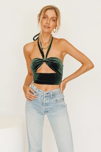 Detail of dark green velvet halter crop top with knot bow design and cutout front