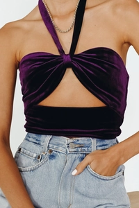 Close-up of purple velvet halter top featuring a twist front and cutout detail