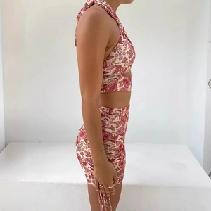 Pink paisley two-piece set featuring a halter crop top and bodycon mini skirt