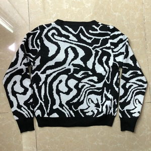 Flat lay back view of long-sleeve knit cardigan with black and white wavy patterns