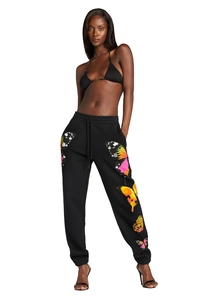 Close-up of black sweatpants featuring vibrant butterfly print and adjustable drawstring