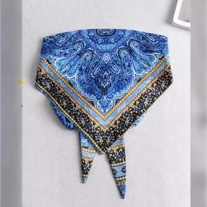 Blue and orange paisley silk-like bandana scarf in a flat lay triangle fold display
