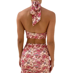 Women's pink paisley print two-piece set featuring a halter top and drawstring mini skirt