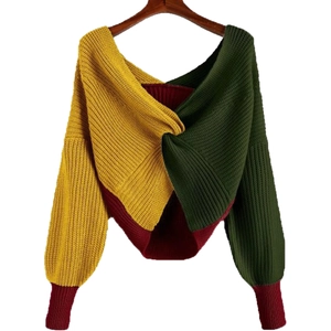 Color-block knit sweater with deep V-neck, twist front detail, and puff sleeves