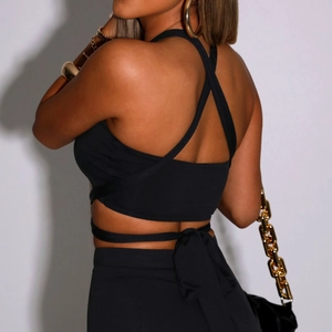 Slim fit halter crop top with criss-cross back straps and matching high waist skirt