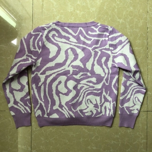 Detail of purple and white irregular zebra swirl pattern on knitted long sleeve cardigan