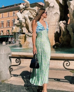 Detail of deep V-neckline and vibrant floral print on a long summer maxi dress