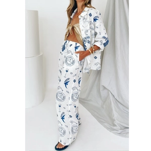 Close-up of hand-painted nautical prints on linen two-piece vacation set shirt and pants