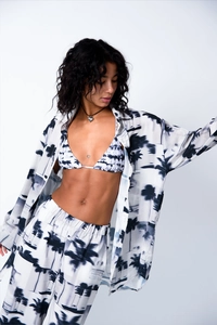 Detail of three-piece women's set with tropical palm tree print and silky texture