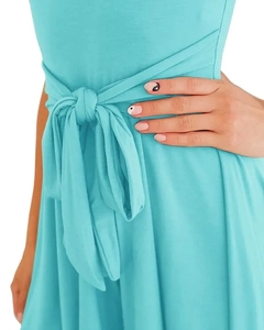 Detailed view of the turquoise knit jumpsuit featuring an adjustable waist tie knot