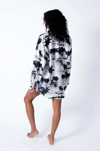 Detailed back view of a white oversized shirt featuring black tropical palm tree prints