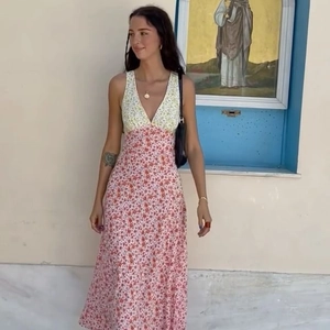 Detail of high-waist floral maxi dress featuring a contrast patchwork print and deep V-neckline