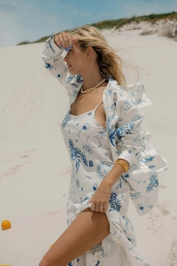 Detail of the blue artistic print on white linen-feel beach maxi dress with open back