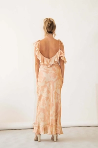 Detail of ruffle trim on an apricot floral backless maxi dress with satin finish