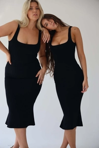 Detail view of black velvet fishtail dress showing sleek fit on two different body types