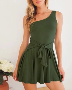Detail of dark green one-shoulder romper with tie-waist and ruffled hemline