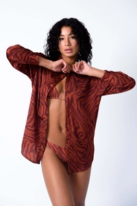 Detail of rusty red zebra print shirt and matching bikini set with breathable fabric