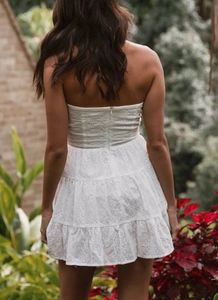 Detail of bohemian white eyelet lace dress with open back and invisible zipper design